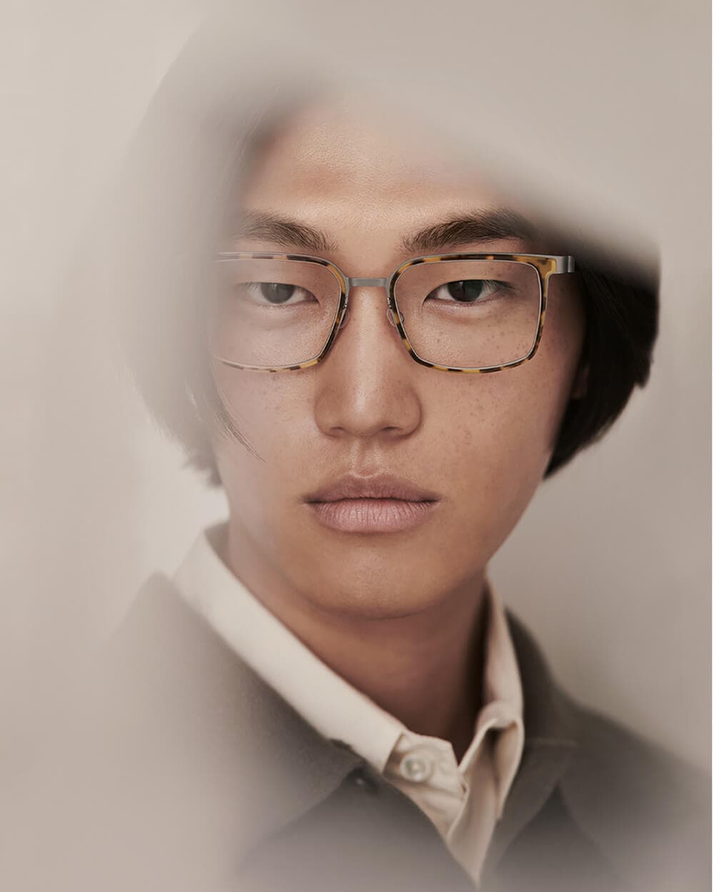 mann mit gelb schwarzer havanna korrektionsbrille von lindberg und grauer weste